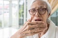 Asian senior woman checking breath and breathe,old elderly have bad breath,bad smell,stink,foul mouth from inside the oral,tongue Royalty Free Stock Photo