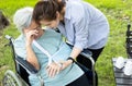 Asian senior woman crying suffering elbow arm fracture, broken bone,old people is injured in accident wearing arm sling after