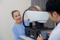 Asian senior woman examining eyesight modern measurement machine equipment by eye specialist in clinic. Royalty Free Stock Photo