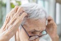 Asian senior woman experiencing an itchy scalp,symptoms of fungal or bacterial infections,diseases of Seborrheic dermatitis and