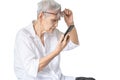Asian senior woman with eye glasses,try to read messages,gaze at the small text on mobile phone,age related macular degeneration, Royalty Free Stock Photo