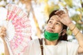 Asian senior woman fanning and sweat on face suffer from sunburn very hot in summer weather problem feel faint, tired female Royalty Free Stock Photo