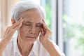 Asian senior woman has headache,touching her head with her hands,communicates the symptoms of vertigo;dizziness;migraine;sick Royalty Free Stock Photo
