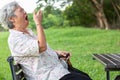 Asian senior woman has sleepy expression,elderly woman yawning covering open mouth with hand,old people feeling yawn,doze,sleepy Royalty Free Stock Photo