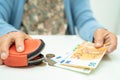 Asian senior woman holding counting coin money and Euro bnaknotes in purse. Poverty, saving problem in retirement Royalty Free Stock Photo