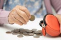 Asian senior woman holding counting coin money in purse. Poverty, saving problem in retirement Royalty Free Stock Photo