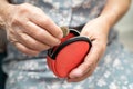 Asian senior woman holding counting coin money in purse. Poverty, saving problem in retirement Royalty Free Stock Photo