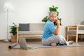 Asian senior woman lifting dumbbell for exercise and workout at home. Active mature woman doing stretching exercise in living room Royalty Free Stock Photo