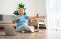 Asian senior woman lifting dumbbell for exercise and workout at home. Active mature woman doing stretching exercise in living room