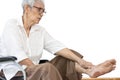 Asian senior woman massaging ankle and feet,old elderly had beriberi,cramp,numbness in her feet,sore toe joints,peripheral Royalty Free Stock Photo