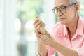 Asian senior woman is massaging her wrists,Elderly woman suffering from pain in hand,arthritis,beriberi,or peripheral neuropathies Royalty Free Stock Photo