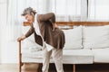 Asian senior woman pain from backache alone at home