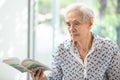 Asian senior woman reading a book relaxed at home,elderly woman spend their free time reading book Royalty Free Stock Photo