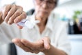 Asian senior woman is squeezing the hand sanitizer on her palm or pour lotion from bottle,cleaning,antibacterial,old elderly wash Royalty Free Stock Photo