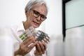 Asian senior woman is stressed about having to take a lot of medicine,medication to treatment,elderly hold medicine pills or