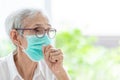 Asian senior woman suffer from cough with face mask protection,elderly woman wearing face mask because of air pollution,Sick old Royalty Free Stock Photo