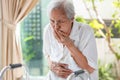 Asian senior woman suffering from abdominal bloating,colic in abdomen,flatulence,accumulation of gas,frequent belching,old elderly Royalty Free Stock Photo