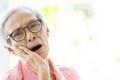 Asian senior woman suffering from toothache,tooth decay,feeling pain,female elderly people holding her cheek with hand,teeth Royalty Free Stock Photo