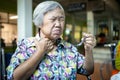 Asian senior woman suffers from choke,clogged up food,elderly people choking during feeding,food might stuck in the throat and Royalty Free Stock Photo