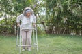 asian Senior woman try to walking with walker falling in garden park and having knee pain. kneel Arthritis pain concept. old Royalty Free Stock Photo
