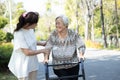 Asian senior woman use walking aid during rehabilitation,elderly people encourage,assisting,care,support her best friend practice Royalty Free Stock Photo