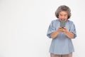 Asian senior woman using smartphone over white background Royalty Free Stock Photo