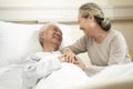 Asian senior woman visiting husband in hospital