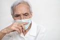 Asian senior woman wearing medical face mask,rubbing nose with her finger,itchy and inflamed,old elderly with nose allergy caused Royalty Free Stock Photo