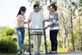 Asian senior woman use walking aid during rehabilitation after physical therapy or knee surgery, elderly people practice walking, Royalty Free Stock Photo