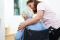 Asian senior woman on wheelchair with caregiver help support walking down the stairs prevent accident, slip and fall at home Royalty Free Stock Photo