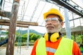 Asian senior worker engineer wearing helmet and safety clothes in the house construction site. Working elderly people concept Royalty Free Stock Photo