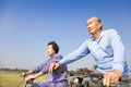 Asian seniors couple biking Royalty Free Stock Photo