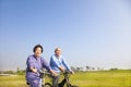 Asian seniors couple biking in the park Royalty Free Stock Photo