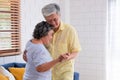 Asian seniors couple enjoy dancing in living room at home.aging at home concept Royalty Free Stock Photo