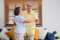 Asian seniors couple enjoy dancing in living room at home.aging at home concept Royalty Free Stock Photo
