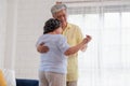 Asian seniors couple enjoy dancing in living room at home.aging at home concept Royalty Free Stock Photo