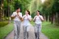Asian Seniors and Daughter Jogging and Relaxing in the Park, Family Bonding in Nature, Seniors and Family Enjoying Exercise and