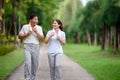 Asian Seniors and Daughter Jogging and Relaxing in the Park, Family Bonding in Nature, Seniors and Family Enjoying Exercise and