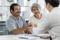 Asian seniors who are healthy, in a good mood, smiling, talking with financial or life insurance staff to take care of life after