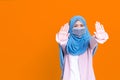 Asian serious muslim woman wears hijab, makes cross with hands over chest, Royalty Free Stock Photo