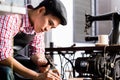 Asian shoe or belt maker in his leather workshop Royalty Free Stock Photo