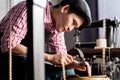 Asian shoe or belt maker in his leather workshop Royalty Free Stock Photo