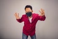 An Asian short hair man in red shirt posing stop sign by his hands Royalty Free Stock Photo