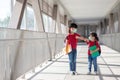 Asian sibling with face mask going back to school after covid-19 quarantine and lockdown Royalty Free Stock Photo