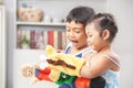 Asian sibling playing hand puppet