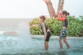 Asian sibling playing in swimming pool Royalty Free Stock Photo