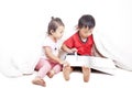 Asian siblings reading book