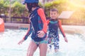 Asian siblings running and chasing in Swimming pool