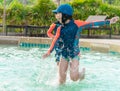 Asian siblings running and chasing in Swimming pool