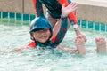 Asian siblings swimming and chasing in Swimming pool